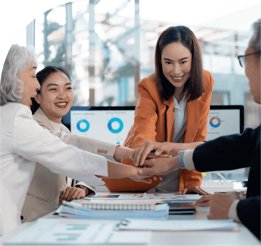 Team members joining hands during a demand forecasting session
