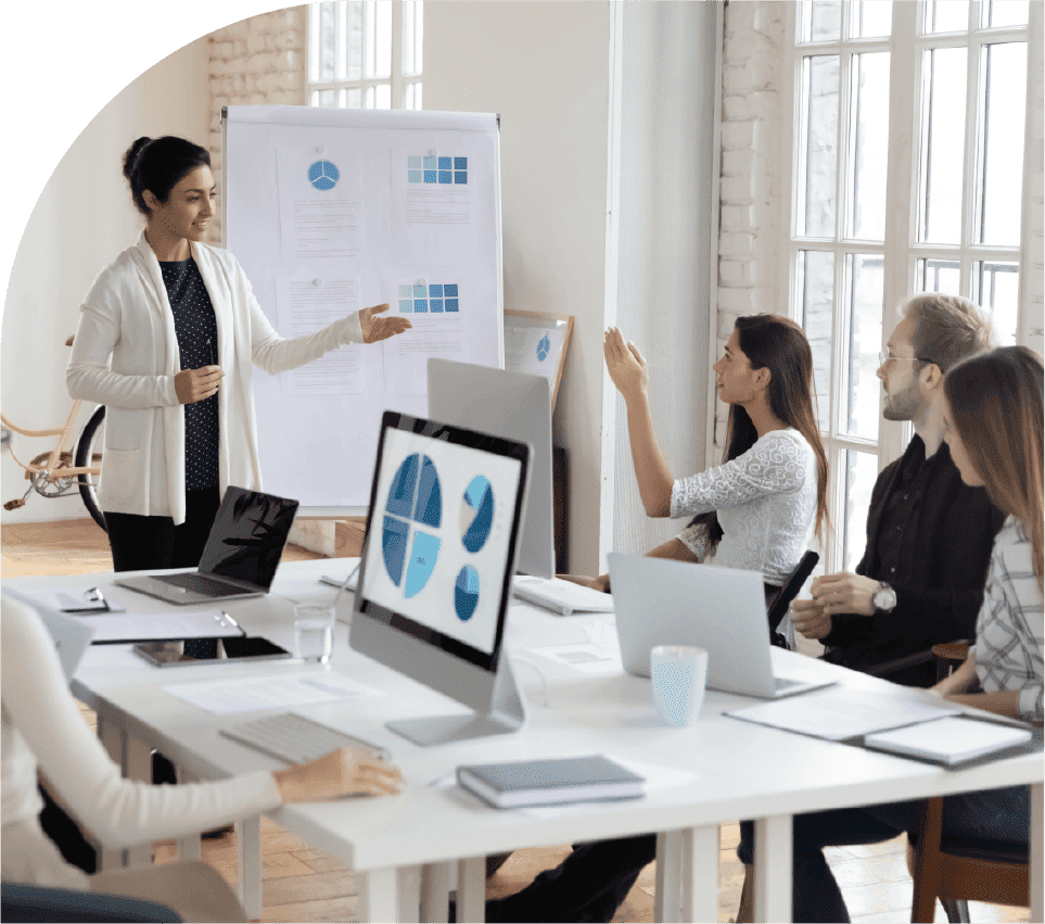 Team reviewing performance charts and portfolio priorities in a meeting
