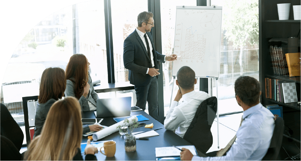 Professionals discussing SAVIOM’s training scheduling software capabilities